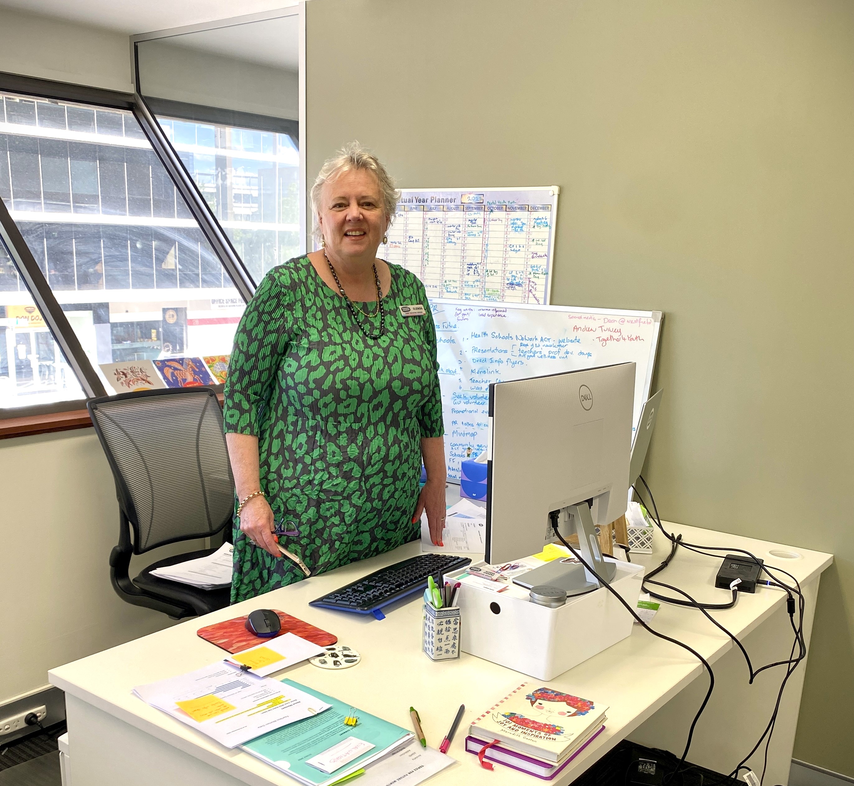 Fearless Women CEO, Glenda Stevens standing at her donated desk