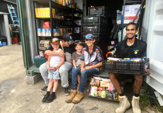 Waminda staff and volunteers in front of the organisation's food pantry