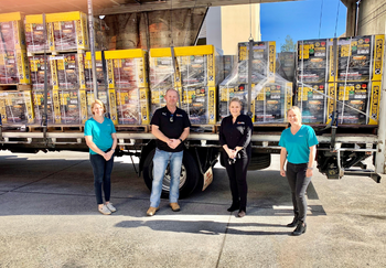 GIVIT Engagmenet Officers Denim Rose and Kirsty Bender standing in front of a truck of donated generaotrs with a male and female employee from Enhance Logistics, who provided free freight transport